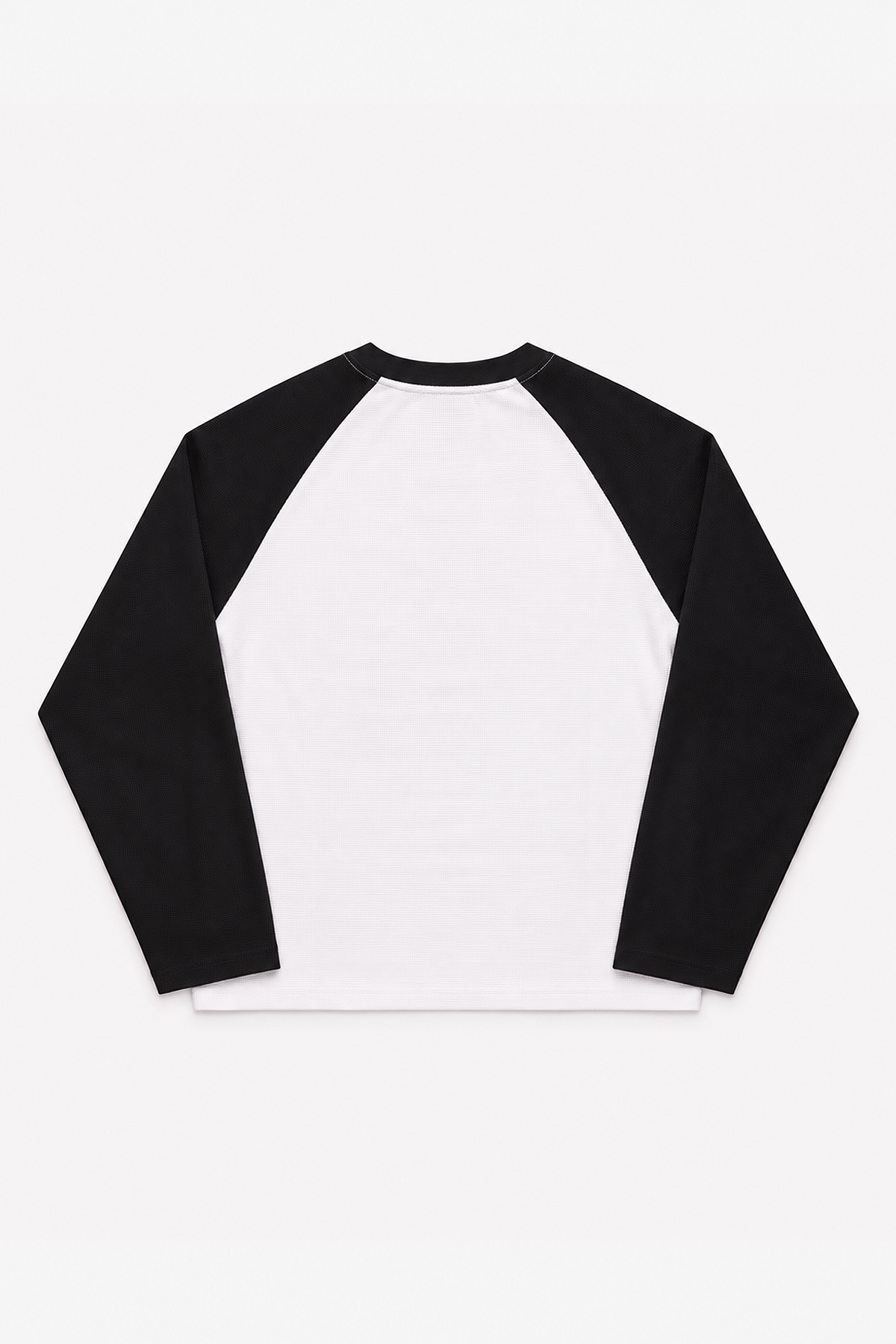 Plain back of the Seattle Waffle Long Sleeve with white waffle body and black raglan sleeves